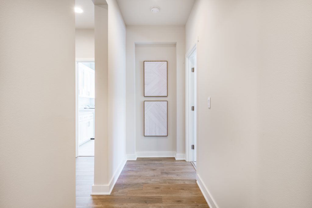 Hall way to primary bedroom, take a left to mud room, utility room and garage